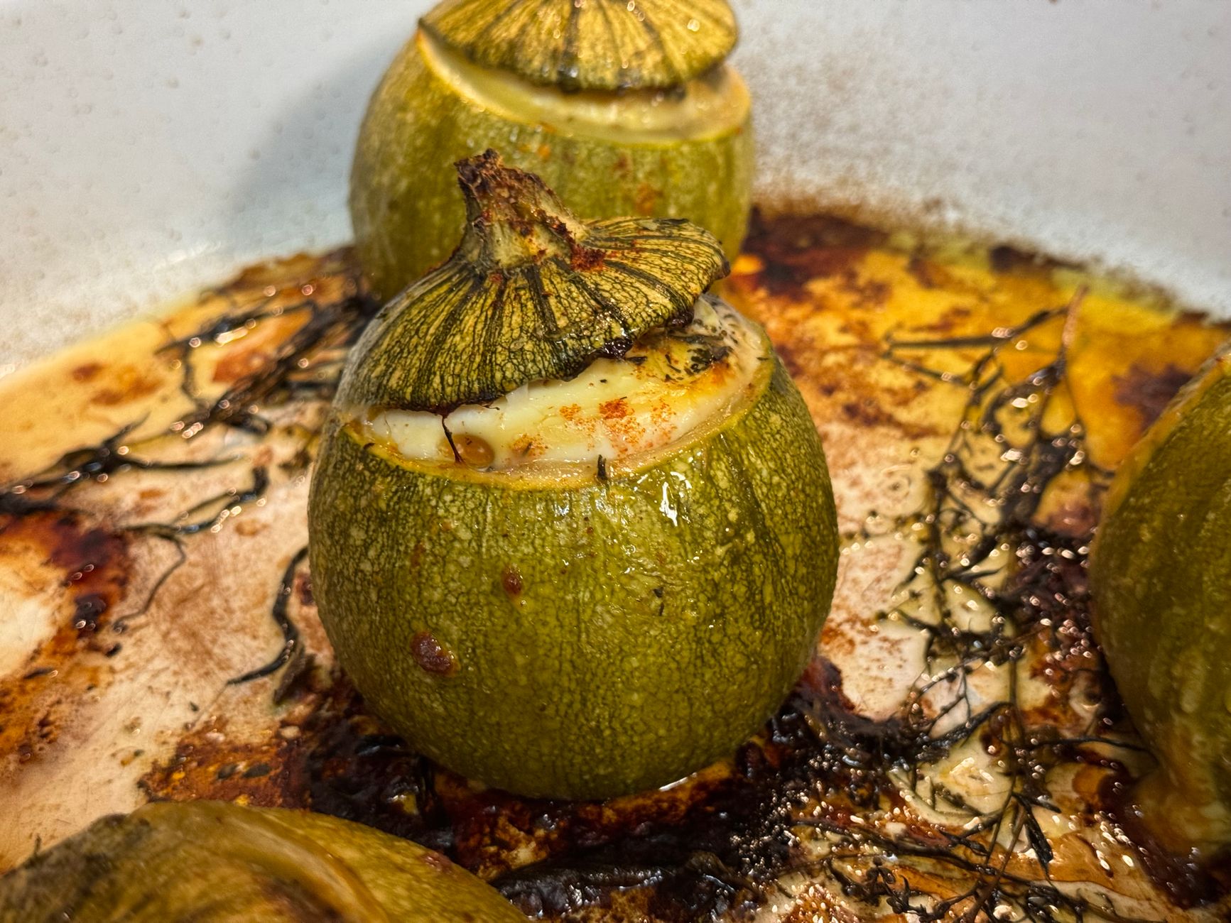 Delicious roasted round zucchini stuffed with a savory filling, perfect for a gourmet meal.