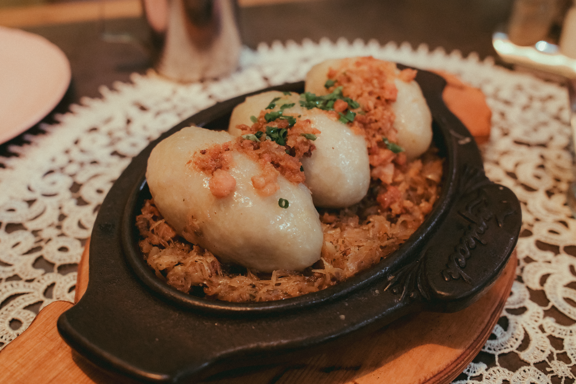 Delicious Polish dumplings served with crispy toppings on a rustic plate, perfect for a hearty meal.