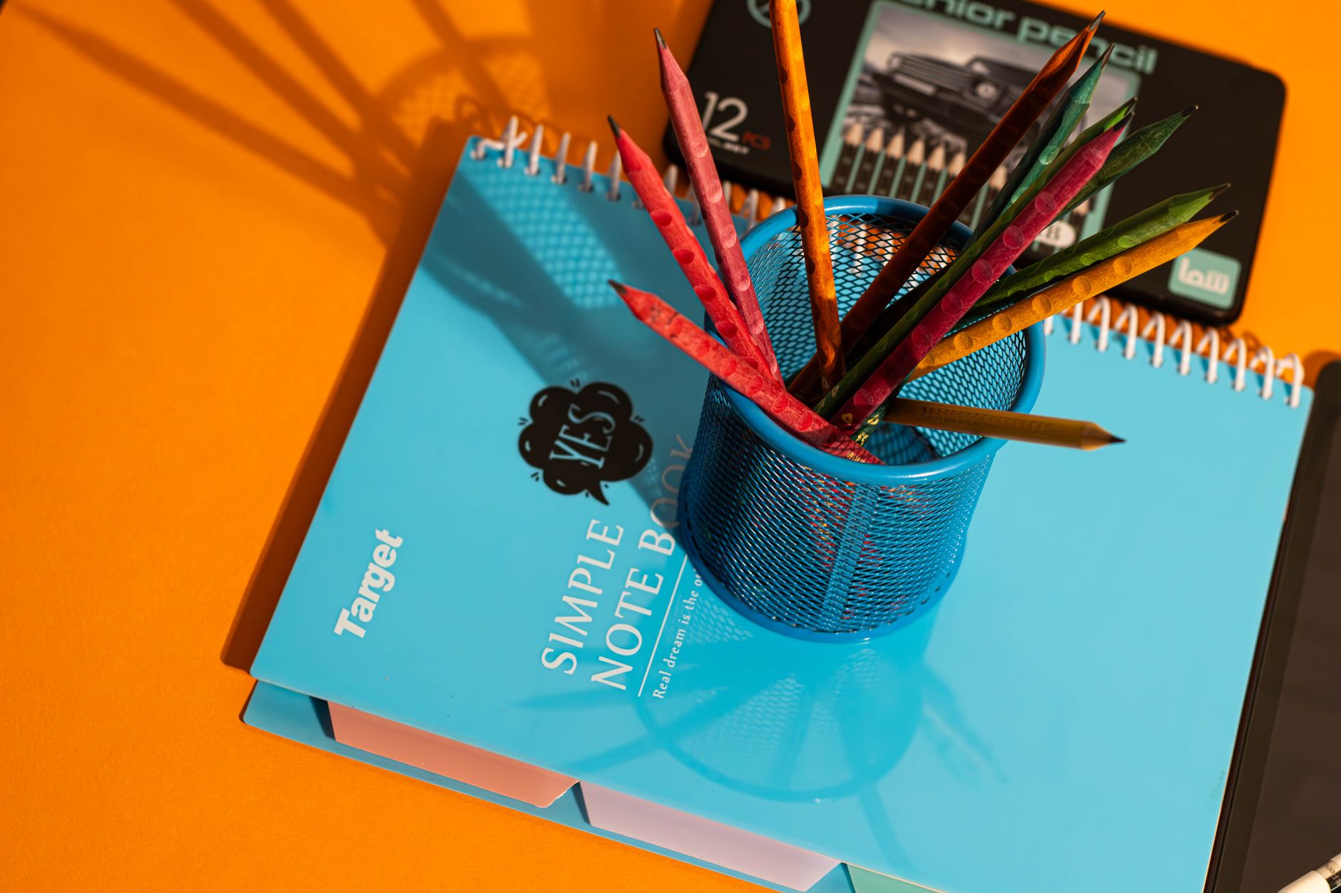 Bright school supplies arrangement with colored pencils, notebooks, perfect for back-to-school themes.