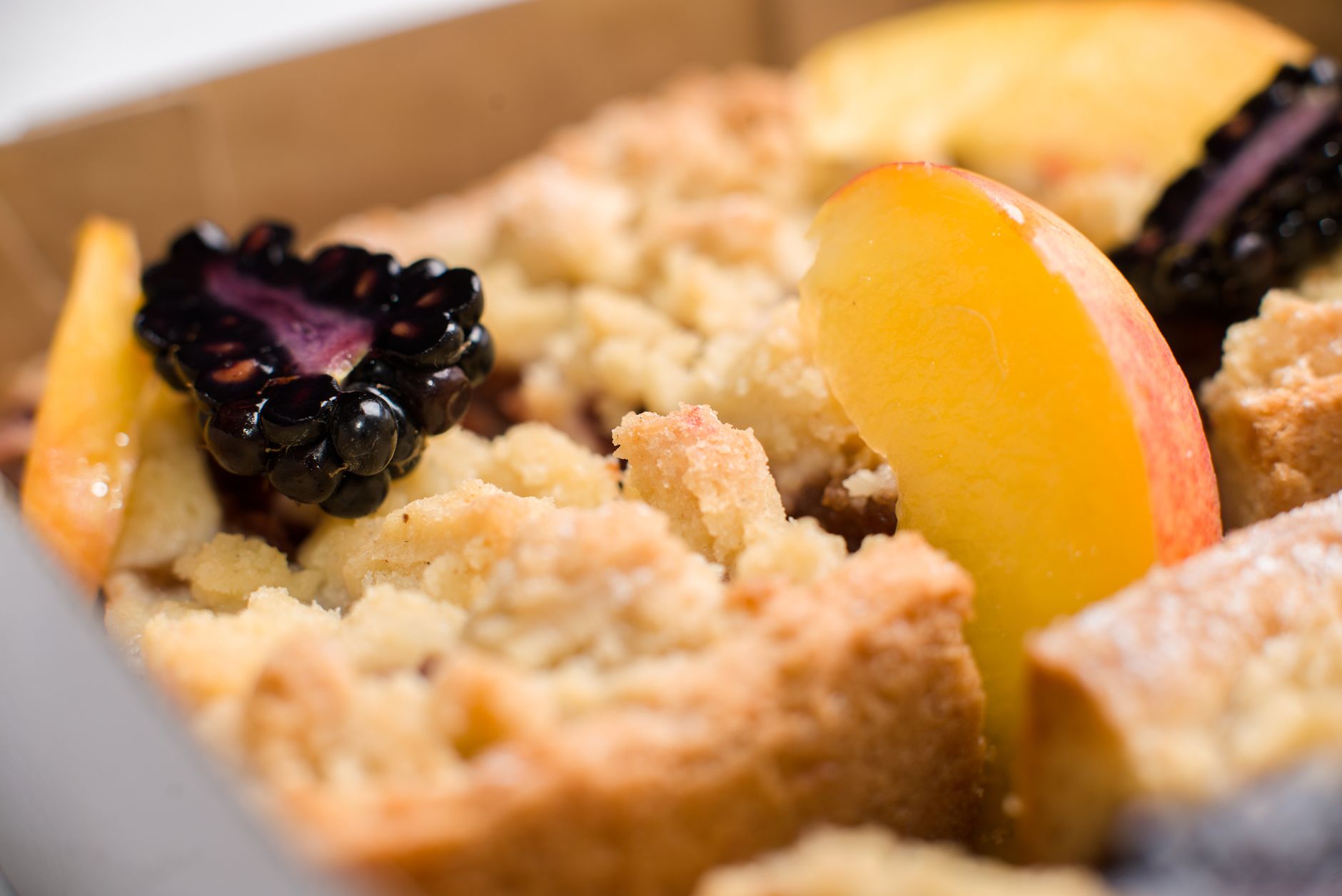 Delicious peach and blackberry cobbler with a golden crumbly crust, perfect dessert.
