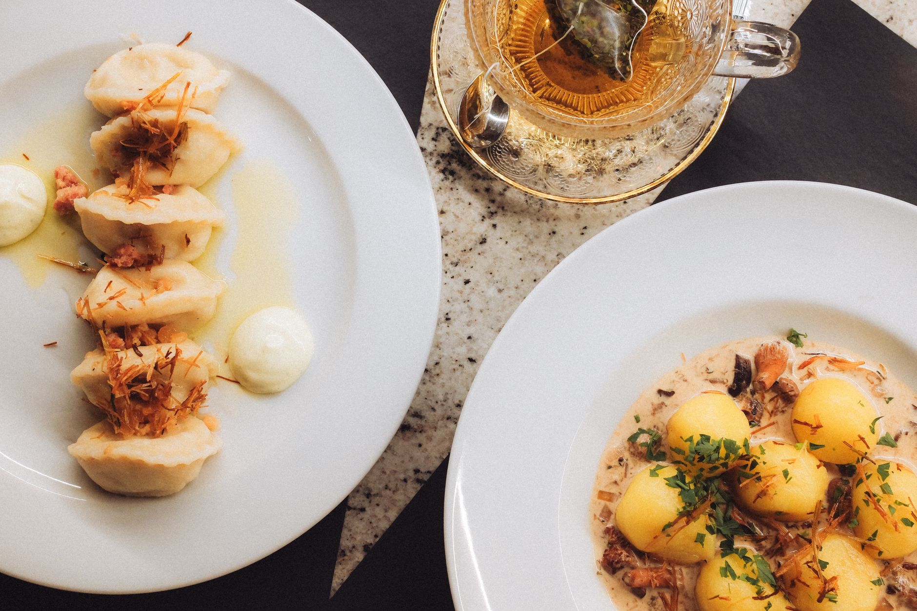 Traditional Polish cuisine featuring dumplings and potatoes served with herbal tea.