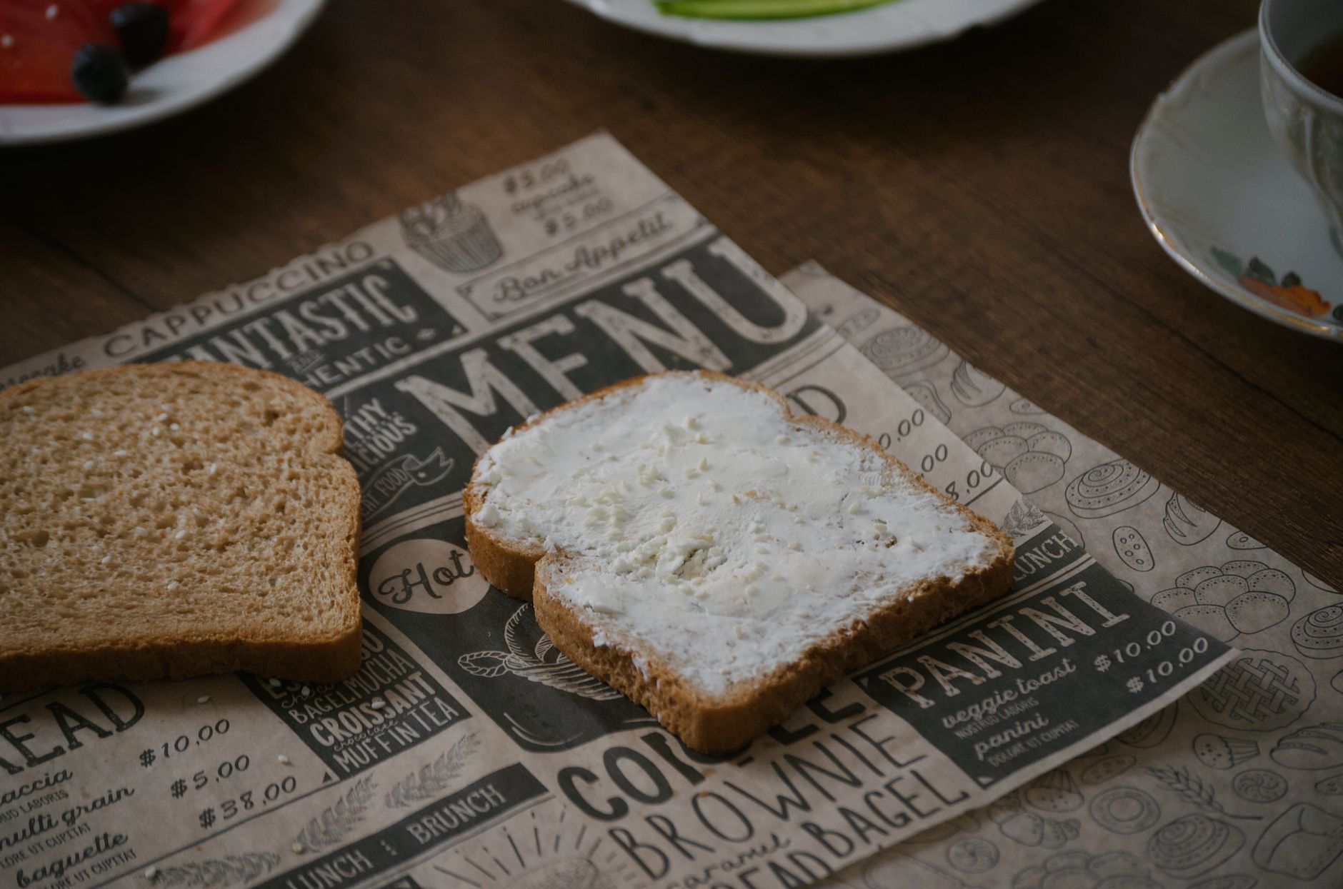 Slices of brown bread with cream cheese on rustic table setting in Türkiye.