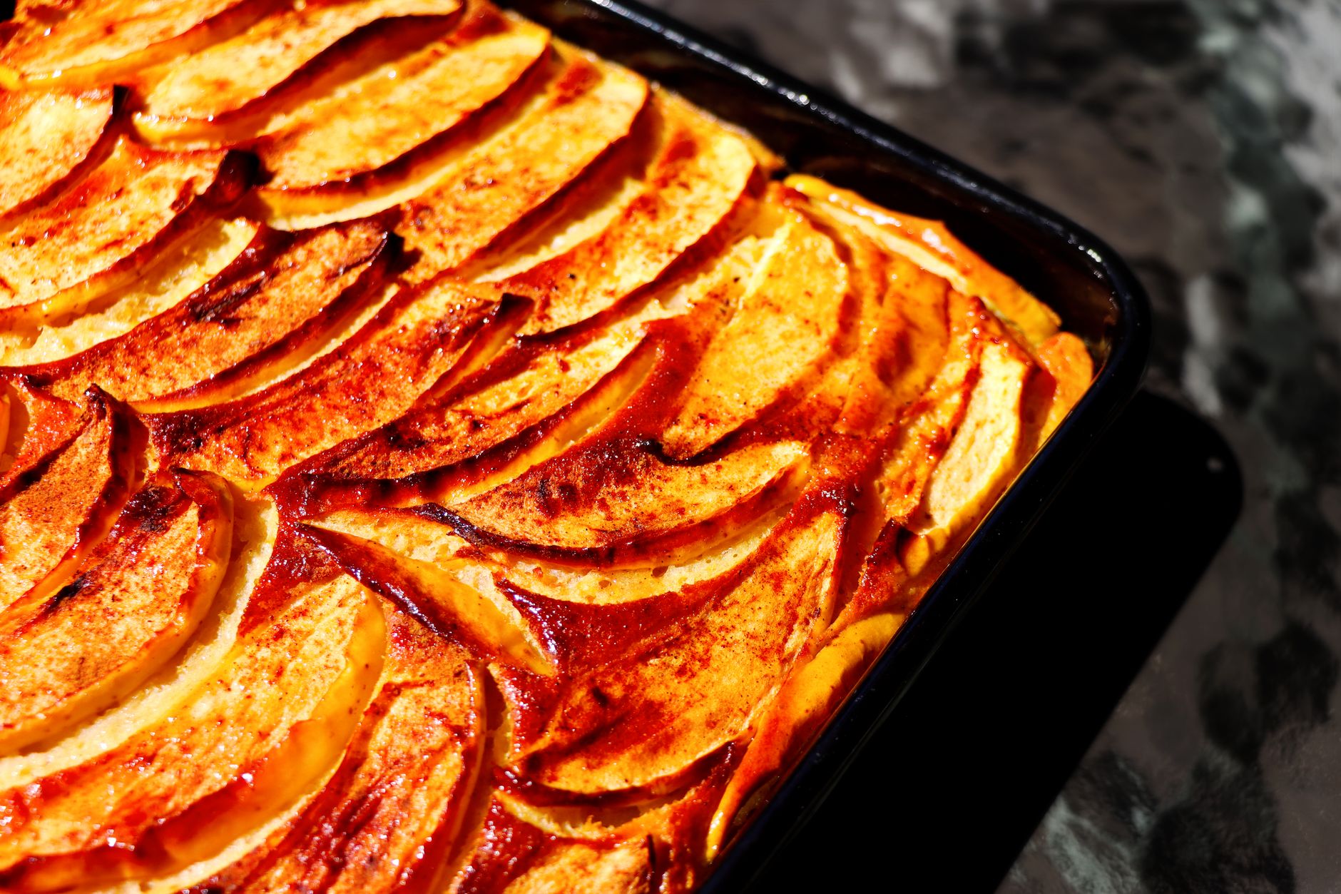 Delicious homemade apple cinnamon cake fresh from the oven, showcasing golden baked apple slices.